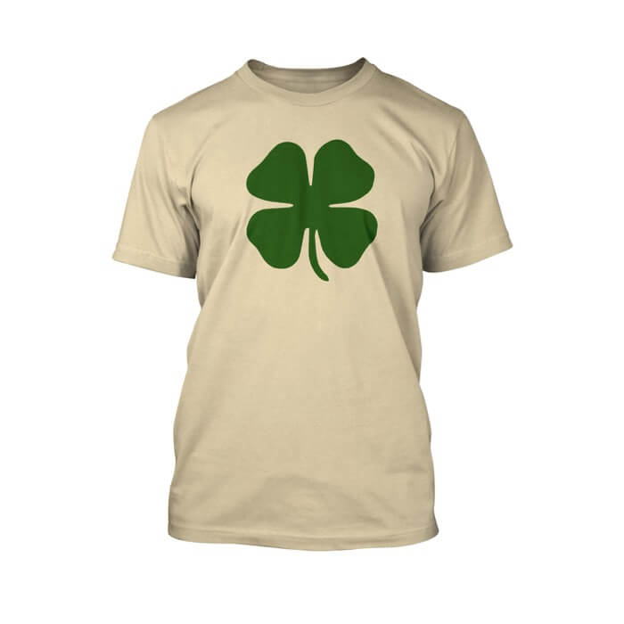 "green clover on the front of a soft cream crew neck unisex t-shirt"